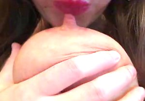 Chick with huge tits sucking on her own nipples