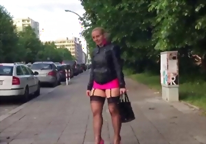 Sweetheart in a pink miniskirt looks good on glossy high heels